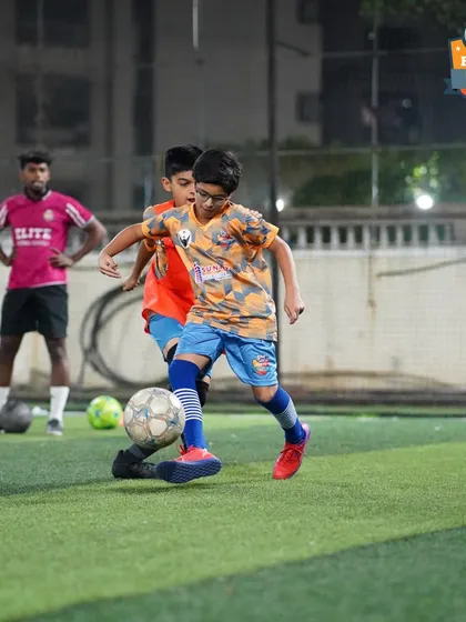 A player shields the ball from a teammate in a practice drill, honing his strength and ball-retention skills.