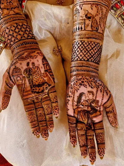 A detailed close-up of the romantic couple portraits on the palms. One palm shows the couple on a swing, while the other depicts a traditional dance pose.