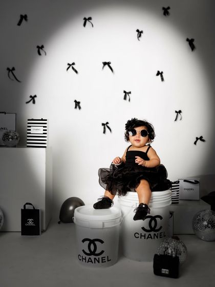 A spotlight shines on the baby sister, giving her a moment in the limelight during this incredibly fun and creative photoshoot.