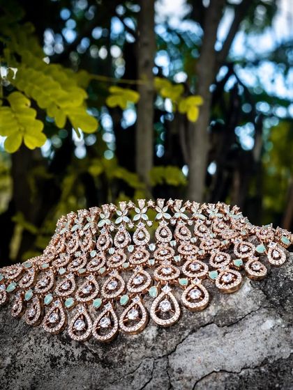 A beautiful shot of our rose-gold finish CZ choker, resting on a rock. This piece is perfect for a modern, chic look.