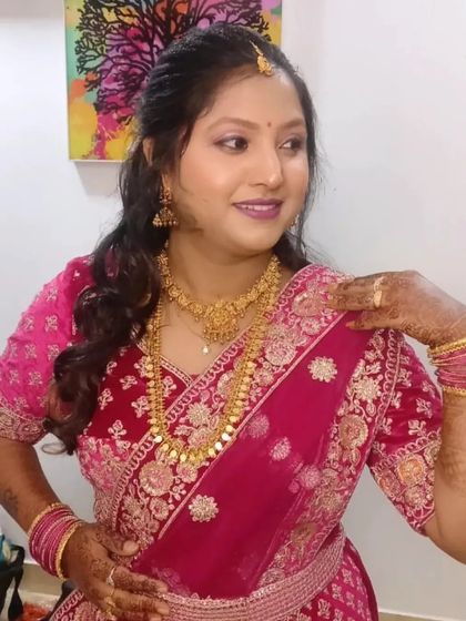 Shwetha looking glamorous for her cousin's wedding in a beautiful pink lehenga. The makeup has a soft shimmer on the eyes and a matching lip.
