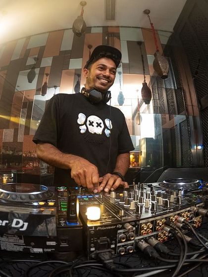 A great shot of me smiling behind the Pioneer DJ setup at i-Bar. This is my happy place, mixing tracks and watching the crowd have the time of their lives.