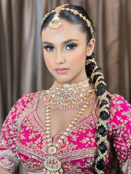 A confident and modern bridal look. The makeup is fresh and glowing, with a focus on beautiful skin.