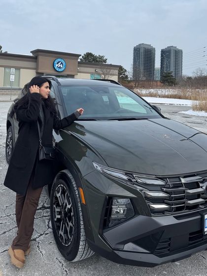 Posing with a new car in a snowy setting, part of a "new beginnings" lifestyle post.