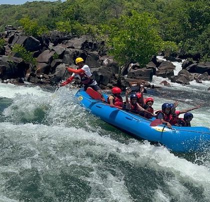 A raft bounces over the waves, capturing the dynamic and thrilling nature of white-water rafting.