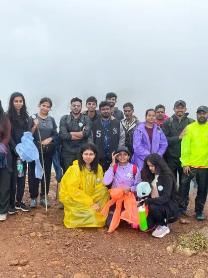 Trekkers in their rain gear, ready for a misty mountain adventure. We guide you through all weather conditions safely.