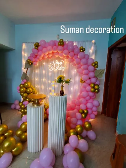 Another view of the at-home pink and gold setup, showing the placement of the cake stands and props.