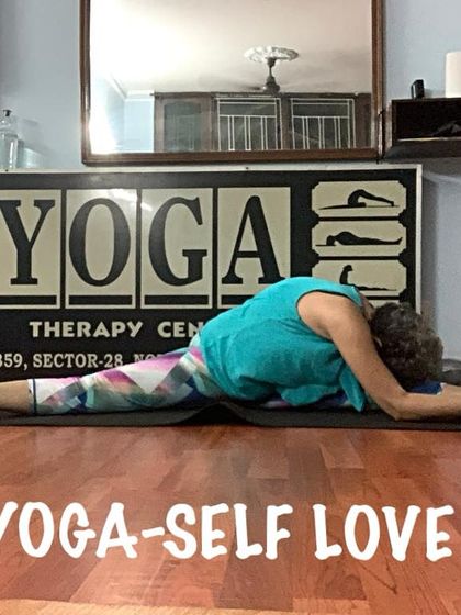 Holding a deep forward bend in a wide-legged split. This posture, known as Upavistha Konasana, is excellent for stretching the entire back of the body.