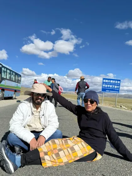 A lighthearted moment on the open road to Kailash. The long bus journeys are an integral part of the yatra, a time for reflection and camaraderie.