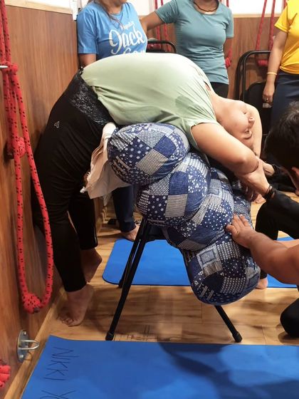 A detailed look at how we use multiple bolsters on a chair to create a supportive arch for Chakrasana (Wheel Pose). This allows for a gradual and safe opening of the spine.