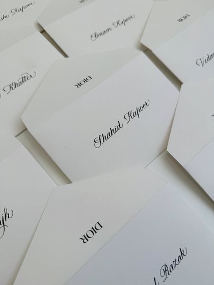 A collection of notecards I personalized with calligraphy for a Dior Beauty event, featuring names of high-profile guests like Shahid Kapoor.
