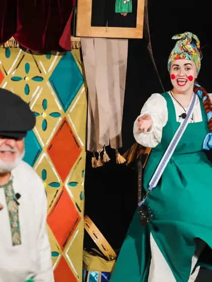 The live performers of 'Petrushka' from Russia. Their colourful costumes and expressive acting complement the hand puppet show happening on stage.