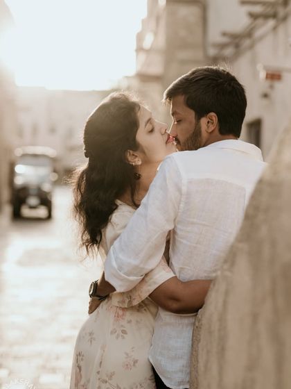 A tender kiss in a sun-drenched alley, creating a beautiful and romantic silhouette effect.