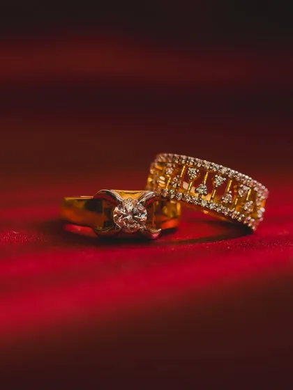 The rings are a symbol of your promise, and I make sure to capture them beautifully. This detailed shot focuses on the engagement rings against a rich, textured background, highlighting the beginning of your lifelong commitment.