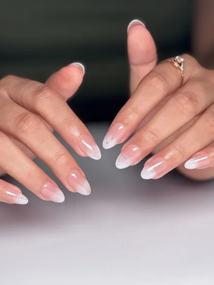 The full two-hand view of the elegant glitter fade French manicure. This is a perfect choice for a wedding, party, or any time you want a touch of sparkle.