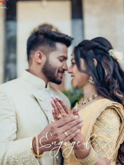Engaged. A close-up shot focusing on the couple's hands and rings, with their faces softly blurred. It's a beautiful, symbolic image of their commitment.