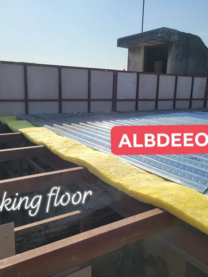 A close-up of the decking floor process. We lay a corrugated decking sheet over the MS frame and add glass wool insulation before finishing the floor. This method is strong, lightweight, and provides great insulation.