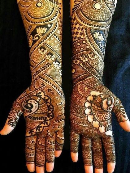 This is a duplicate of image 6. An example of our dense, intricate bridal work. This design features a mix of paisleys, lotuses, and geometric patterns, creating a rich and luxurious look.