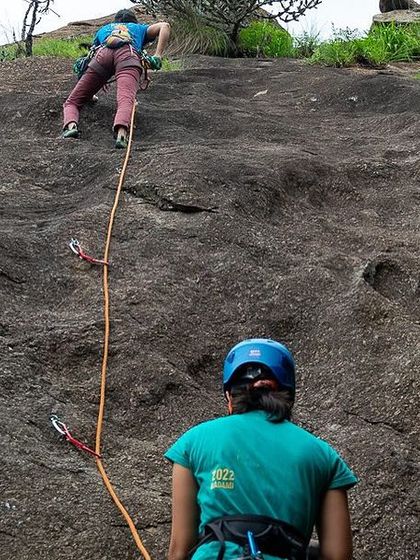 A participant at our women led workshop focuses on her lead climb, with her belayer providing encouragement from below. We teach skills that build confidence for every step of the climbing journey.
