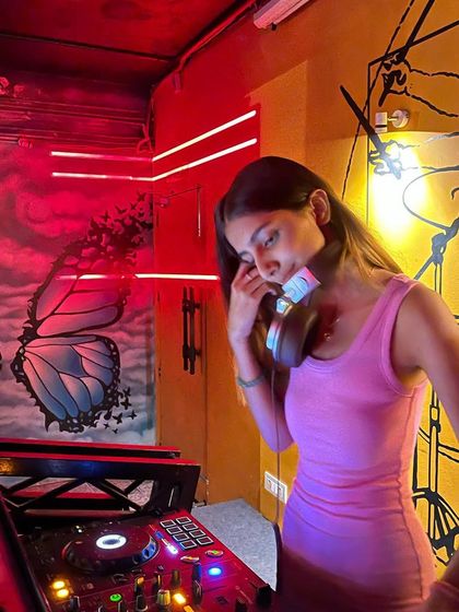 In my element at Beer Tales in Dehradun. The venue's cool butterfly and drum murals, combined with the red neon lights, made for a really unique and vibrant DJing experience.