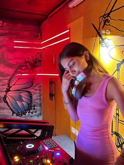 In my element at Beer Tales in Dehradun. The venue's cool butterfly and drum murals, combined with the red neon lights, made for a really unique and vibrant DJing experience.