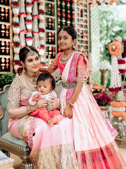 A beautiful portrait of me with my two children. My daughter wears a custom half saree while my son is in a small kurta, all designed to coordinate with my own saree for a family event.
