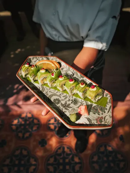 Our Midnight Blossom Uramaki, an indulgent roll of Hass avocado and whipped cream cheese, drizzled with an Asian-style green pepper mayo.