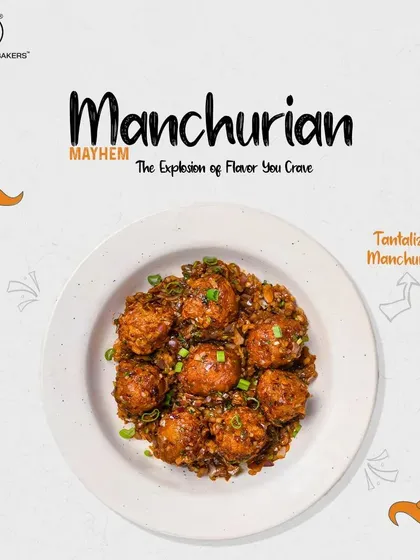 A bowl of our dry Manchurian, highlighting the glossy sauce and fresh garnish. Each bite is an explosion of flavor.
