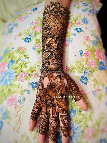 The final look of a custom bridal design. The palm features a portrait of the groom carrying the bride, while the arm continues the story with a majestic peacock and traditional architecture, all tied together with intricate patterns.