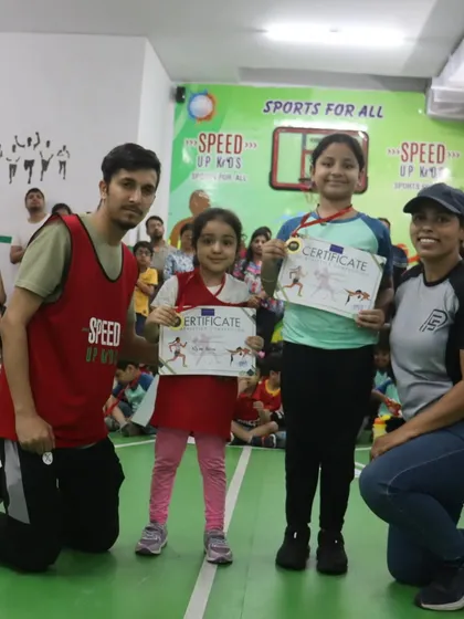 Two winners from our girls' category, proudly showing off their certificates.