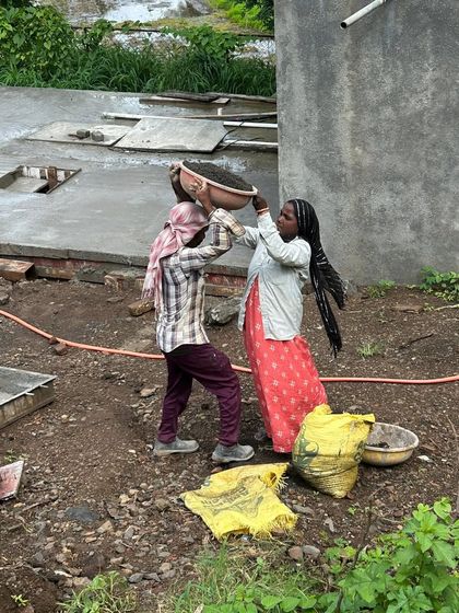 The collaborative effort of our site workers is the backbone of every project. Here, two workers team up to transport materials, showcasing the physical labor and coordination required in construction.