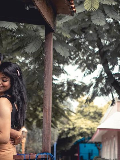 A romantic embrace in a rustic, outdoor setting, with beautiful color grading that enhances the mood of the pre-wedding photo.