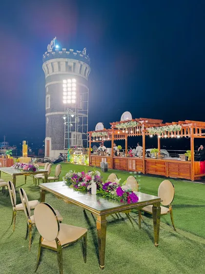 An outdoor catering event at a unique venue with a lighthouse, showcasing my ability to set up in diverse and scenic locations.
