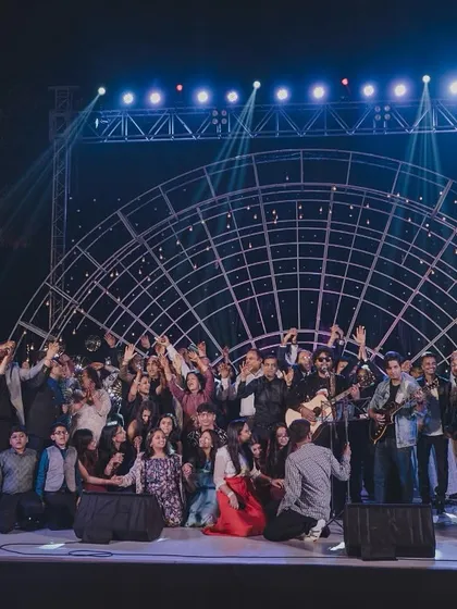 The grand finale of a successful Sangeet night, with all the performers and guests celebrating together on the stage I designed.