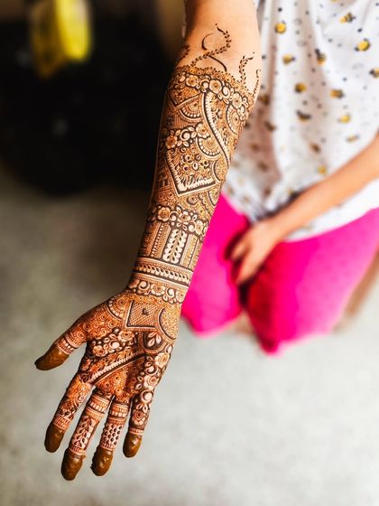 The back of the arm, featuring a large paisley design filled with intricate details.