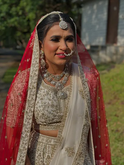 A candid shot capturing the bride's natural glow. The makeup is designed to look fresh and radiant even in bright daylight.