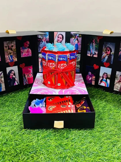This surprise box is one of my favorite things to make. It opens up to reveal a chocolate cake centerpiece surrounded by photo panels, with a hidden drawer below for extra gifts and treats.
