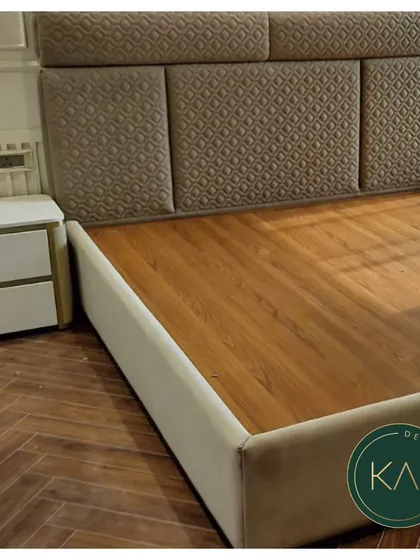This bedroom showcases a bed with a headboard featuring quilted fabric panels. The design adds texture and visual interest, creating a comfortable and stylish focal point in the room.