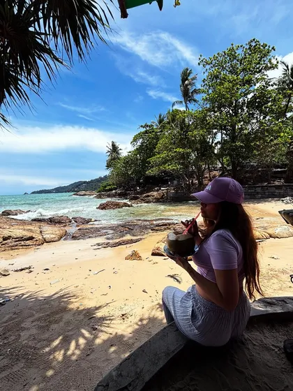 Sipping on fresh coconut water at Patong Beach, Phuket. A classic tropical vacation shot.