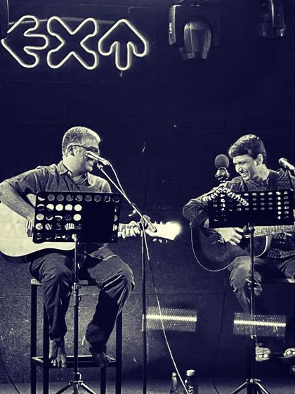 A duplicate of the live performance shot with Vedanth Bharadwaj. The blue tint gives it a cool, moody vibe.