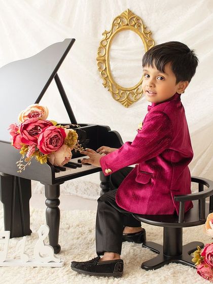 Time for a little concert! This interactive shot shows him pretending to play the piano, adding a fun narrative to the session.