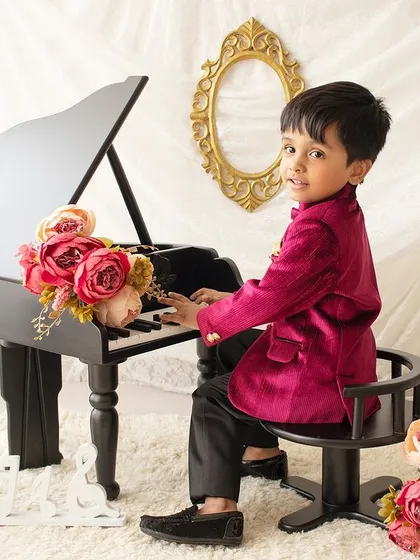 Time for a little concert! This interactive shot shows him pretending to play the piano, adding a fun narrative to the session.