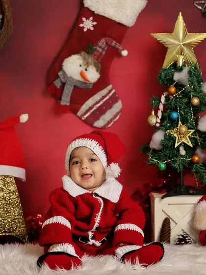 This little boy is all smiles in his Santa suit. Holiday-themed mini-sessions are a wonderful way to create lasting memories and greeting cards.