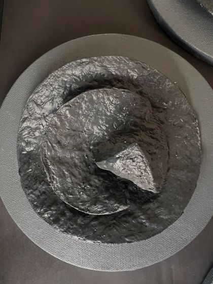 This sculpture has a sharp, almost crystalline structure, showing the versatility of the upcycled paper medium.