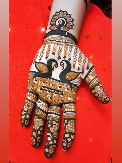 A unique design featuring swans on the palm. The bold, dark fill makes the birds stand out beautifully.