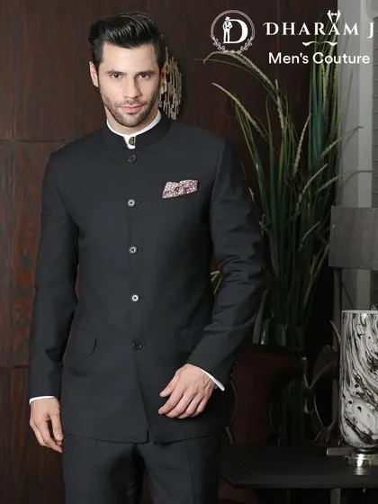 A model wearing a classic black Jodhpuri suit. The clean lines and mandarin collar offer a look of understated sophistication.