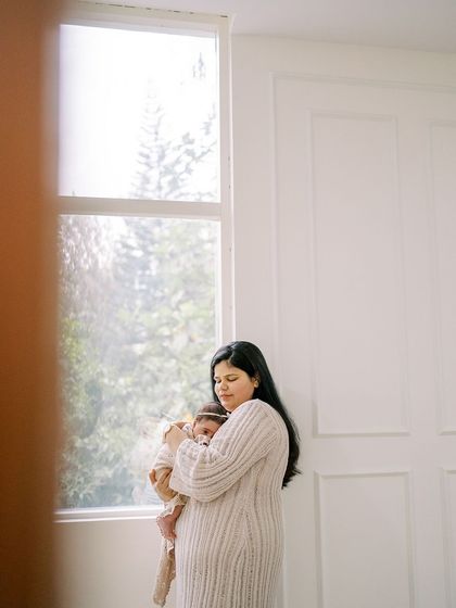 A slightly different perspective of the mother and newborn, framed to create a sense of intimacy and quiet observation.