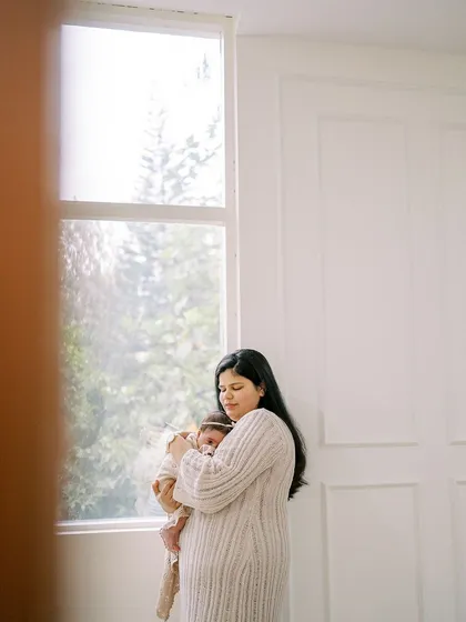 A slightly different perspective of the mother and newborn, framed to create a sense of intimacy and quiet observation.