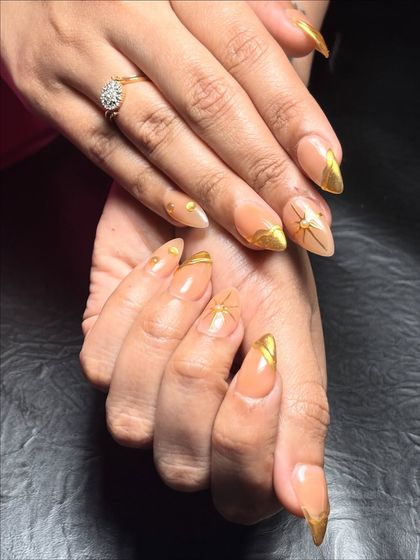 A full set of the golden goddess 3D chrome nails, showing how the design looks with bridal-style jewelry.