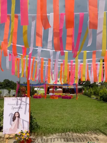 The entrance to the Mehendi ceremony, where guests walk under a canopy of fluttering, colorful ribbons.